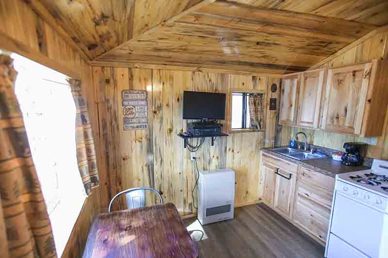 Cabins 16 & 17 kitchen, TV and table.