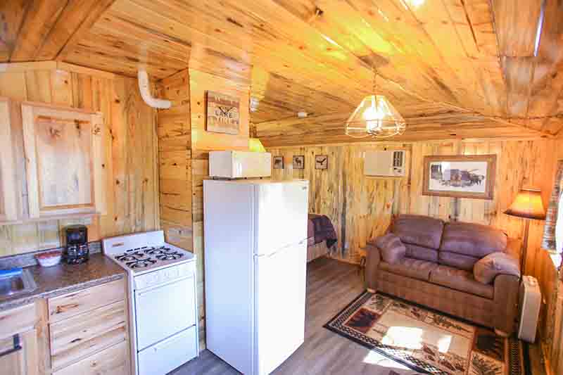 Cabins 16 & 17 loveseat and kitchen.