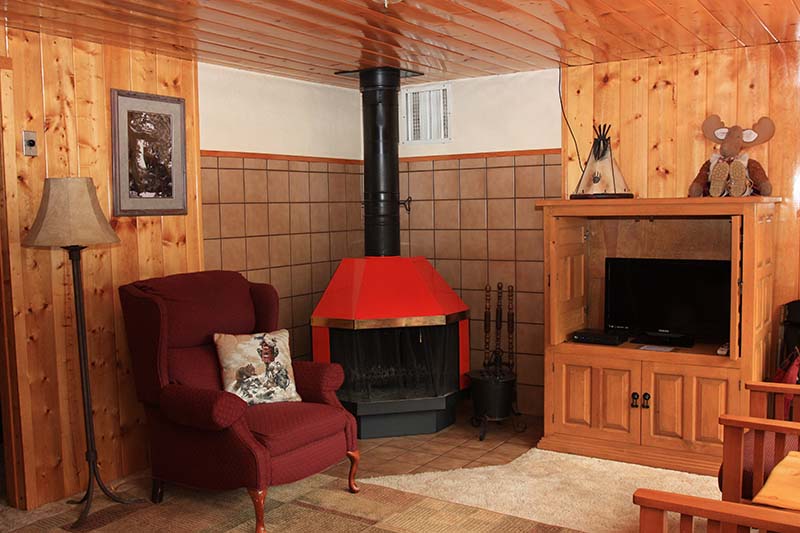 Cabin 2 living room with corner fireplace.