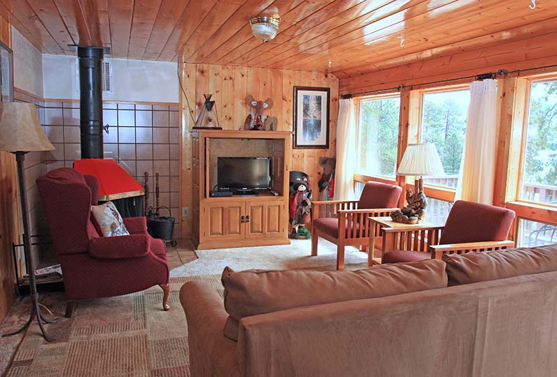 Cabin 2 living room with corner fireplace.